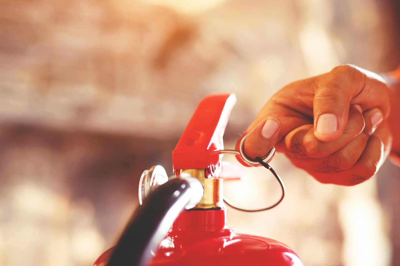 fireman hand holding fire extinguisher available emergencies