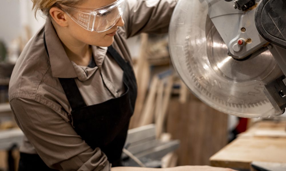 side view female carpenter with tool safety glasses