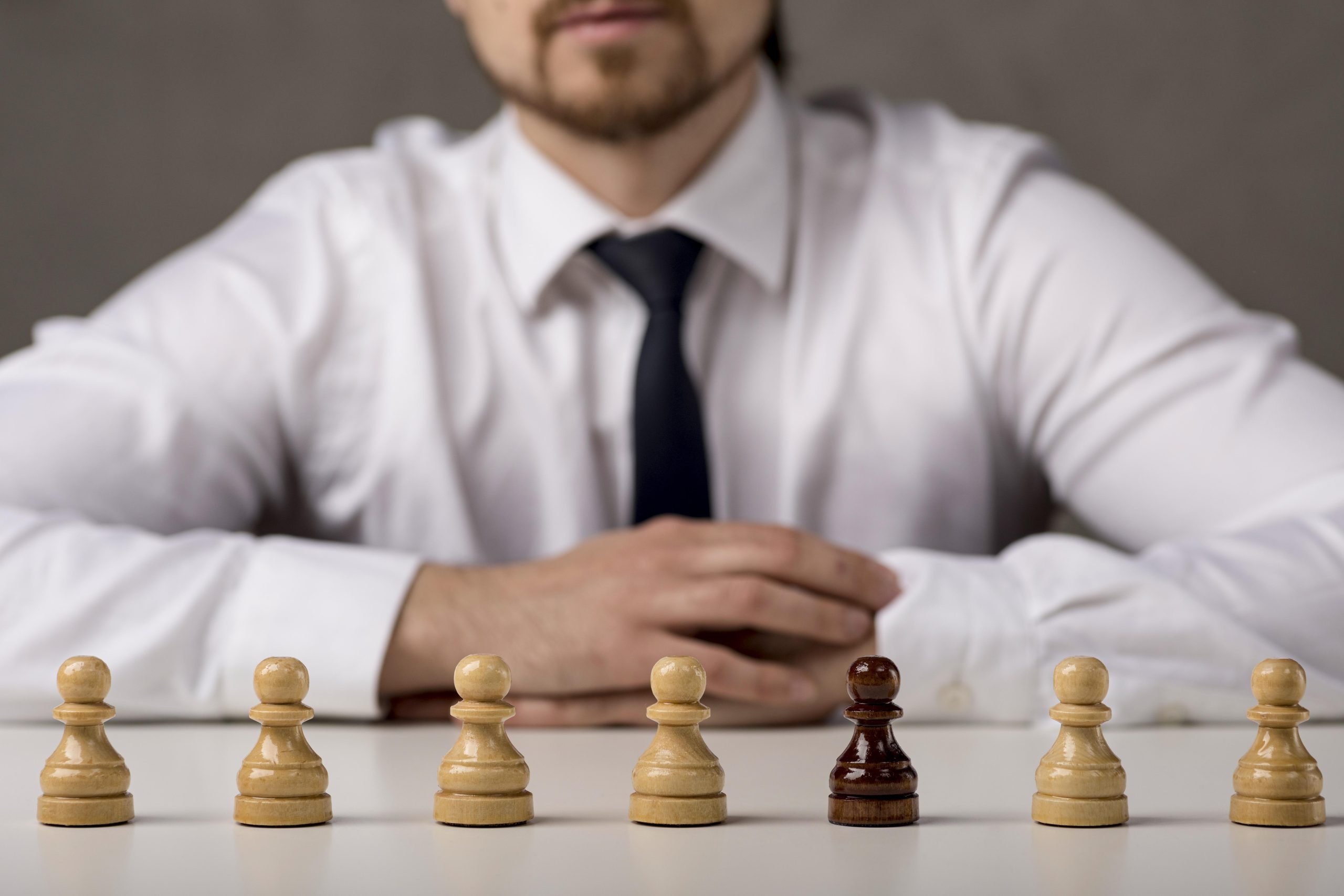 front view business man with pawns scaled